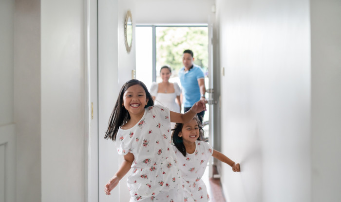 Kids running up the hallway of their home