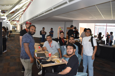 Students sitting around a table having lunch