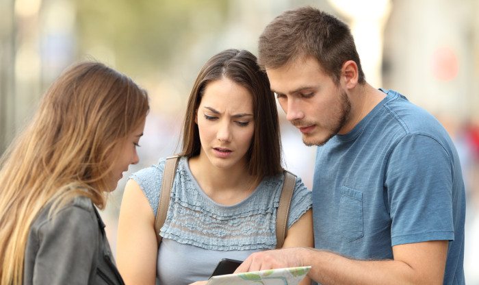 Three people looking at a document