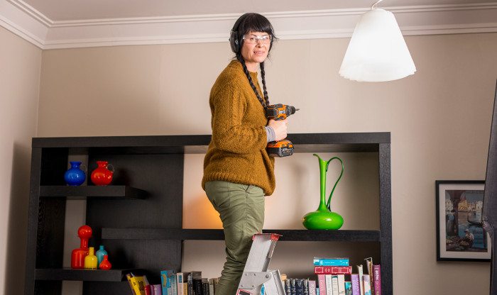 Woman securing tall shelving