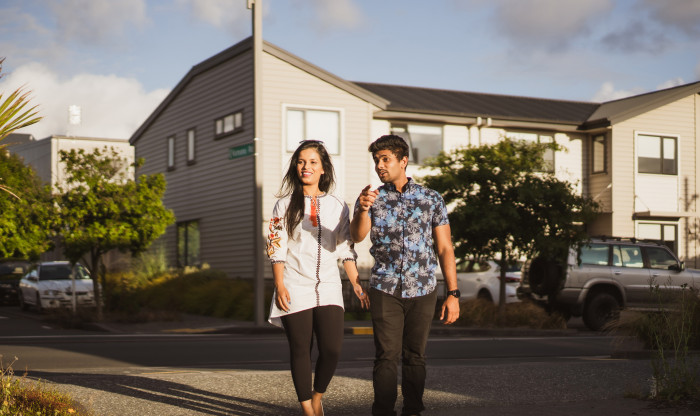 Two people walking down their driveway